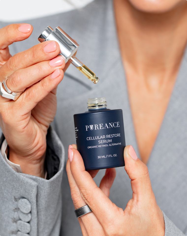 Woman applying Pureance Cellular Restore Serum to her face