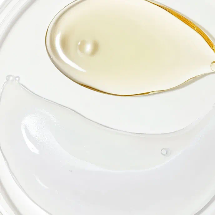 Close-up of two different skincare textures on a white surface