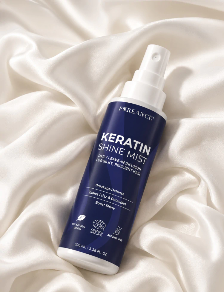 Pureance Keratin Shine Mist bottle resting on white silk