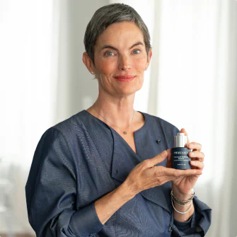 Dr. Sarah Jensen holding Cellular Restore Serum