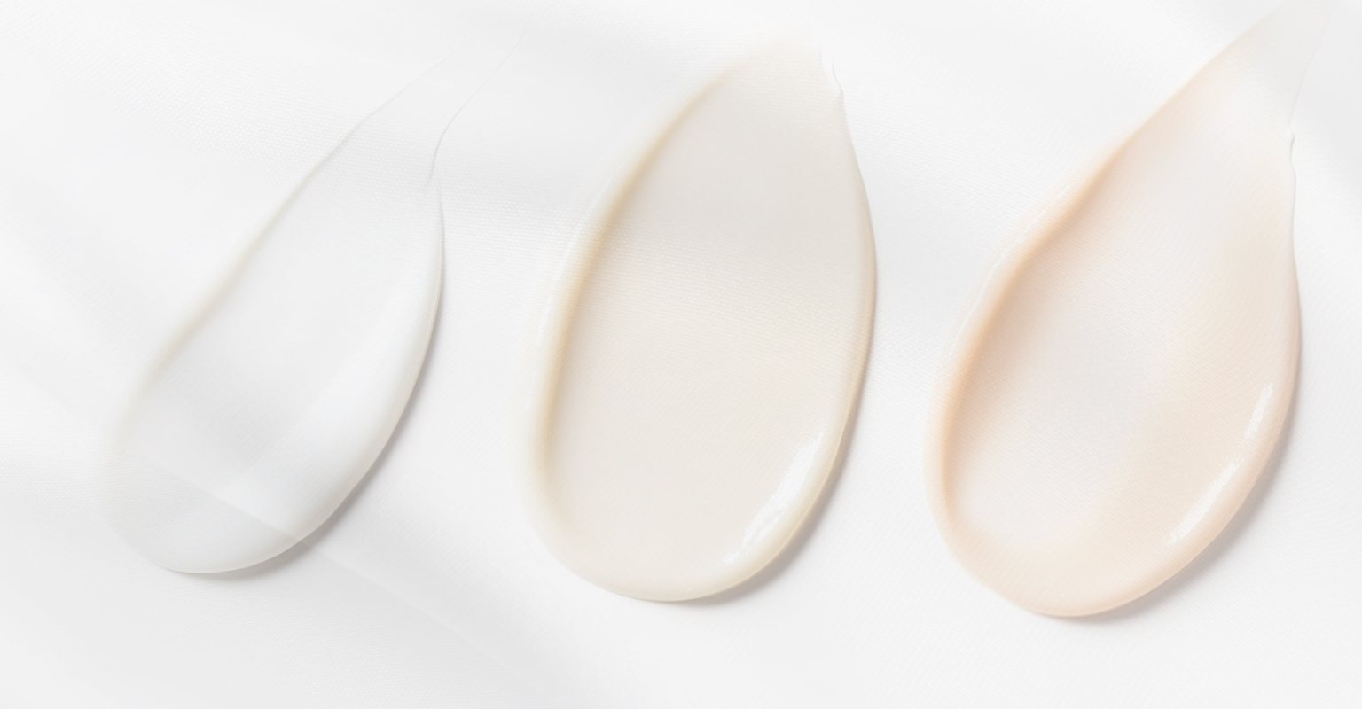 Close-up of smooth, creamy skincare textures in soft lighting