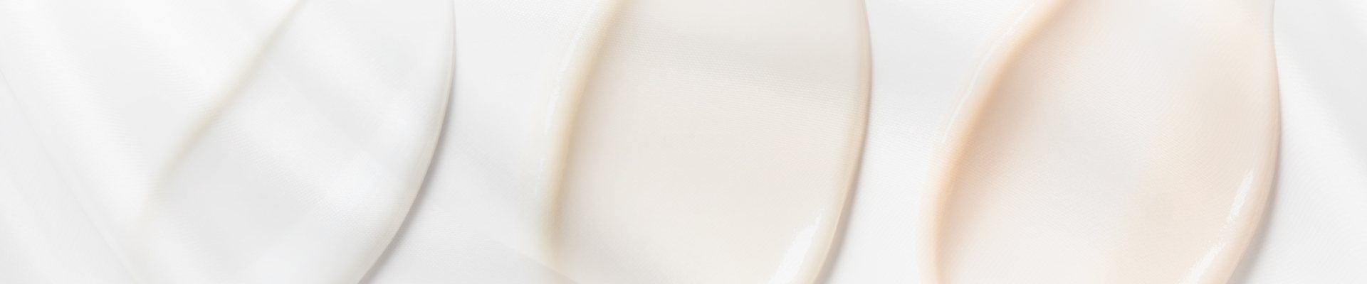 Close-up of smooth, creamy skincare textures in soft lighting