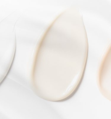 Close-up of smooth, creamy skincare textures in soft lighting